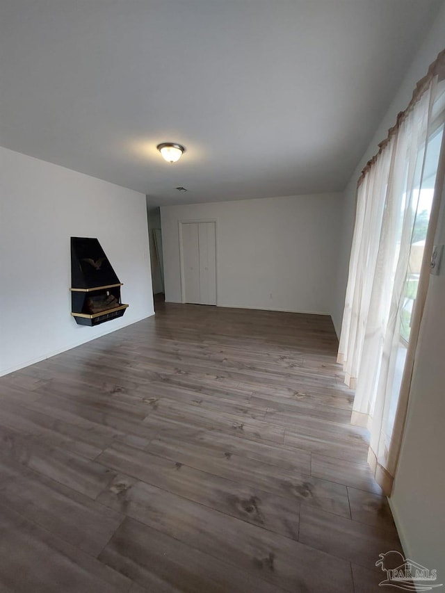 unfurnished living room with wood-type flooring