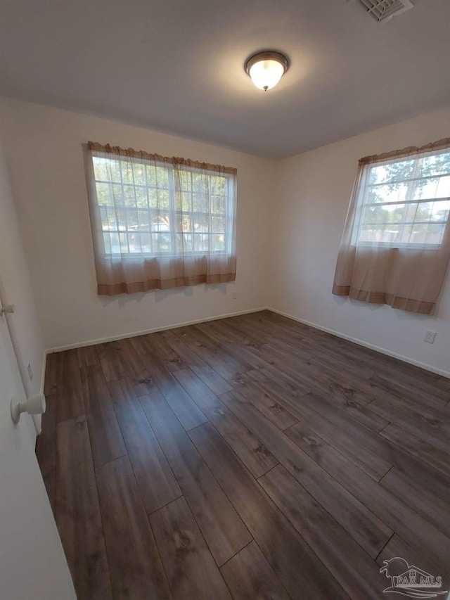 spare room with dark wood-type flooring