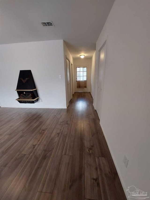 corridor featuring dark hardwood / wood-style flooring