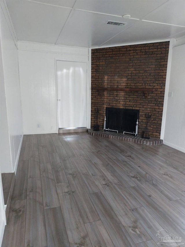 unfurnished living room featuring hardwood / wood-style flooring and a fireplace