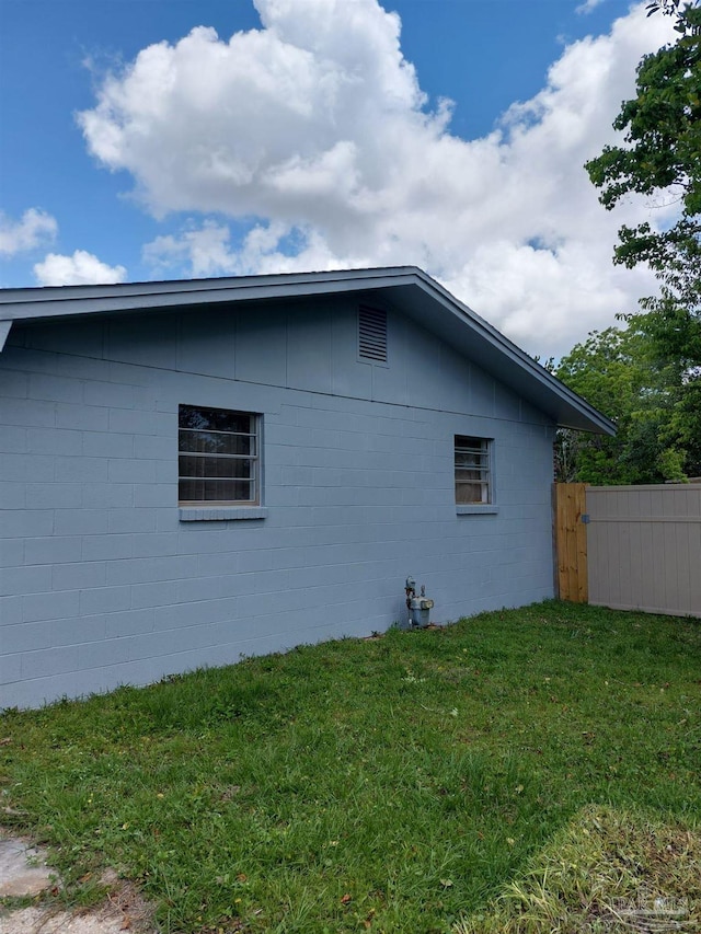 view of property exterior with a yard