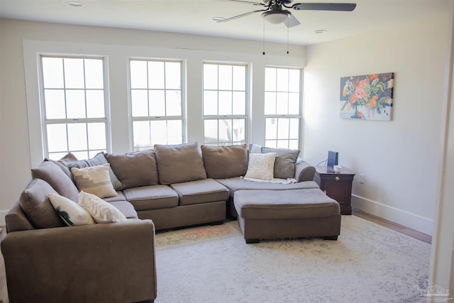 living room with ceiling fan and light hardwood / wood-style flooring