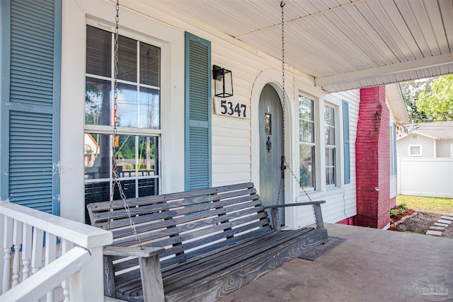 view of exterior entry with a porch