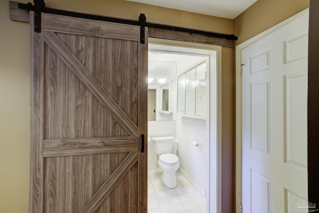 2007 E Gadsden St Unit 102, Pensacola, FL 32501 - bathroom featuring toilet, tile patterned flooring, and baseboards