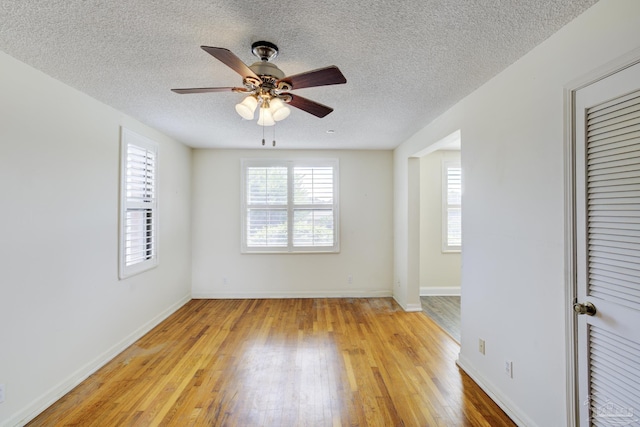2007 E Gadsden St Unit 102, Pensacola, FL 32501 - spare room featuring light wood-type flooring, a ceiling fan, a textured ceiling, and baseboards