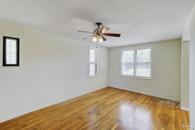 2007 E Gadsden St Unit 102, Pensacola, FL 32501 - unfurnished room featuring light wood-style floors, baseboards, a ceiling fan, and a textured ceiling