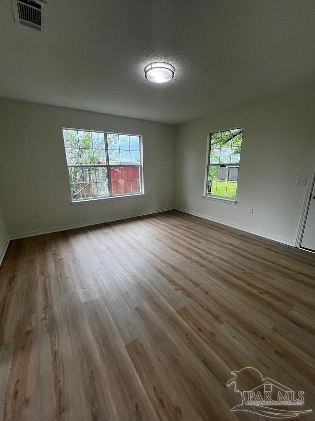 1984 Hillary Thompson Rd, Milton, FL 32570 - spare room featuring wood finished floors and baseboards