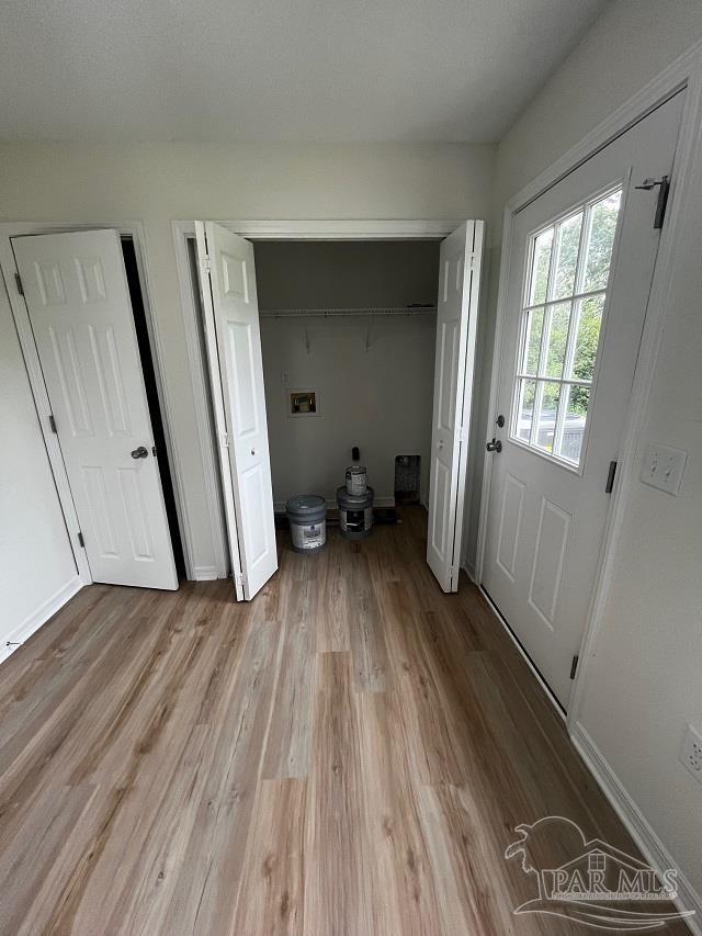 1984 Hillary Thompson Rd, Milton, FL 32570 - laundry area with washer hookup, light wood-style floors, and baseboards