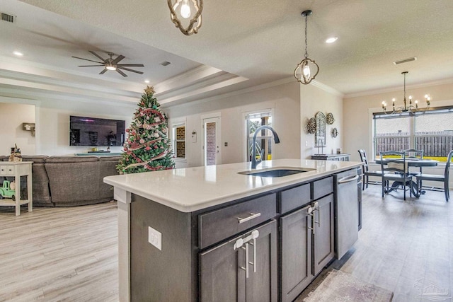 kitchen with a center island with sink, stainless steel dishwasher, a wealth of natural light, and sink