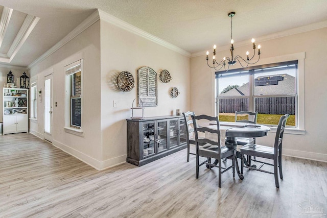 dining space with a chandelier, hardwood / wood-style floors, and crown molding