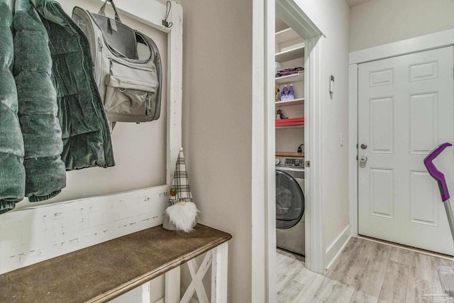 laundry room featuring washer / clothes dryer and light hardwood / wood-style flooring