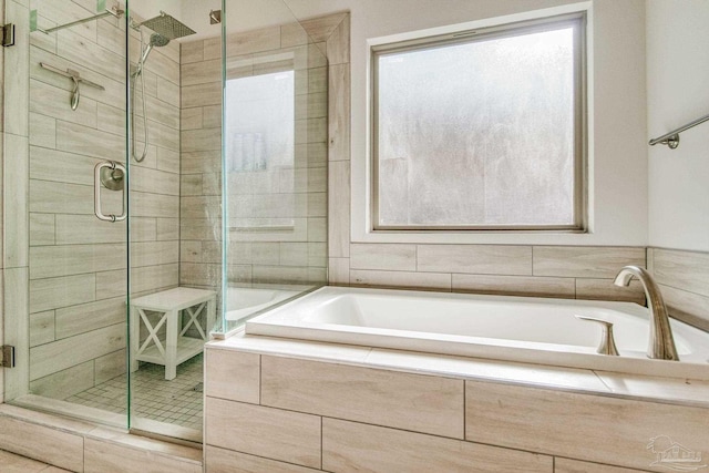 bathroom with shower with separate bathtub