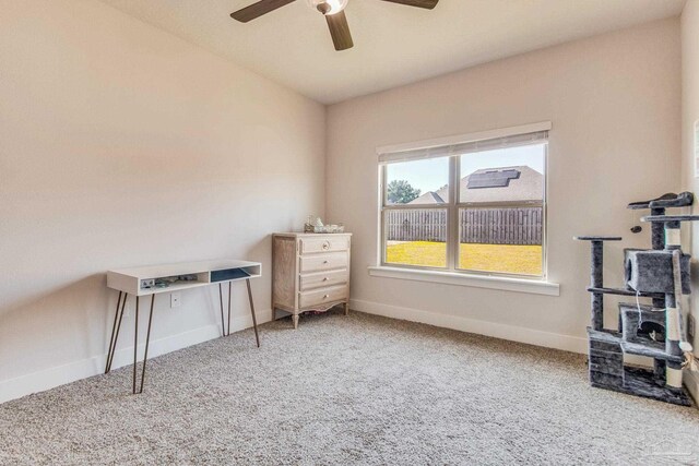 carpeted home office with ceiling fan