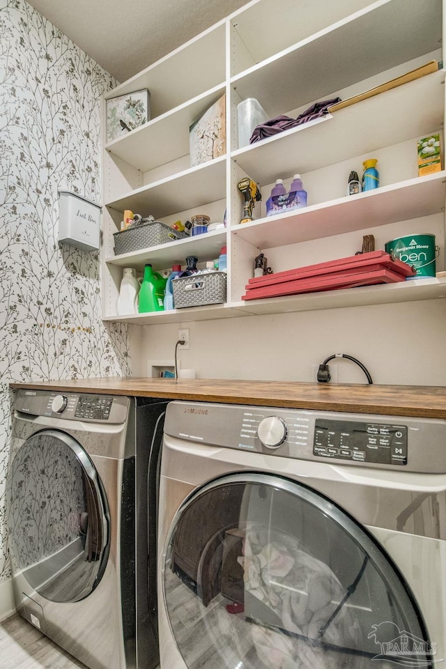 clothes washing area with washer and dryer