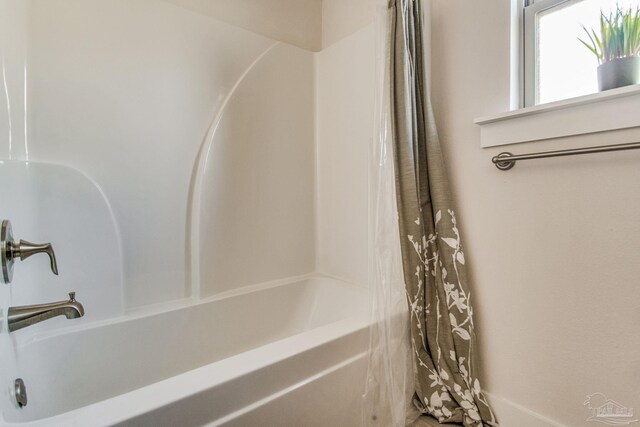 bathroom with shower / bath combo