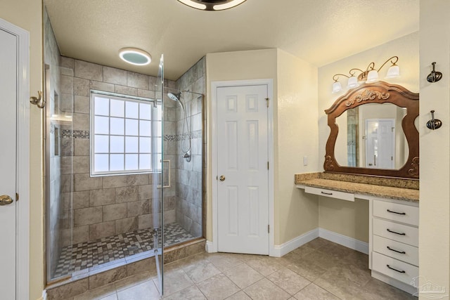 8114 Silver Maple Dr, Milton, FL 32583 - full bathroom with a shower stall, tile patterned flooring, vanity, and a textured ceiling