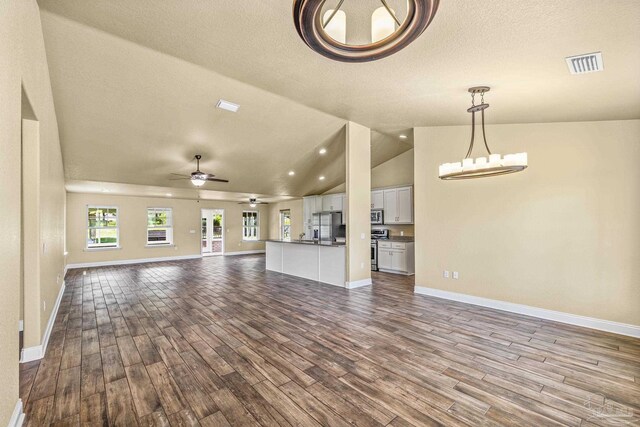8114 Silver Maple Dr, Milton, FL 32583 - unfurnished living room featuring dark wood-style flooring, vaulted ceiling, a ceiling fan, a textured ceiling, and recessed lighting