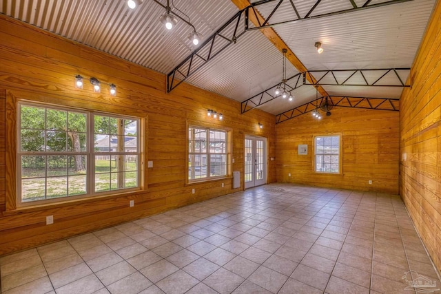 8114 Silver Maple Dr, Milton, FL 32583 - tiled empty room featuring wooden walls and plenty of natural light