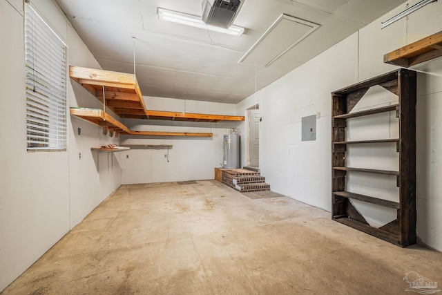 below grade area featuring a garage, electric panel, and gas water heater