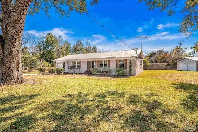 ranch-style house with a garage, a front yard, fence, and an outdoor structure