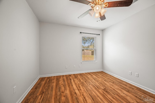 spare room with ceiling fan, baseboards, and wood finished floors