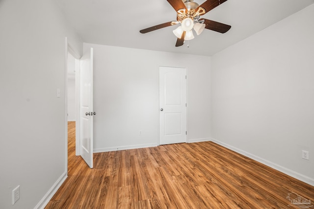 unfurnished bedroom with ceiling fan, baseboards, and wood finished floors