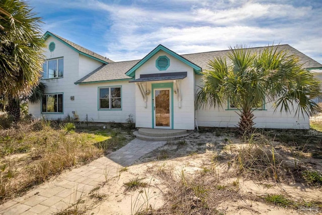 view of front of home with a shingled roof