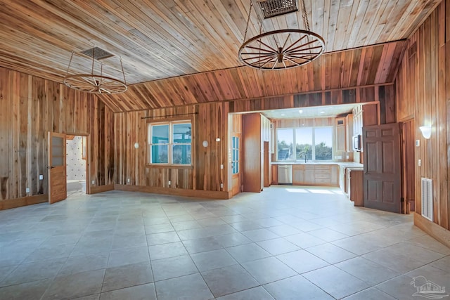 unfurnished living room featuring light tile patterned floors, wood ceiling, wooden walls, and vaulted ceiling