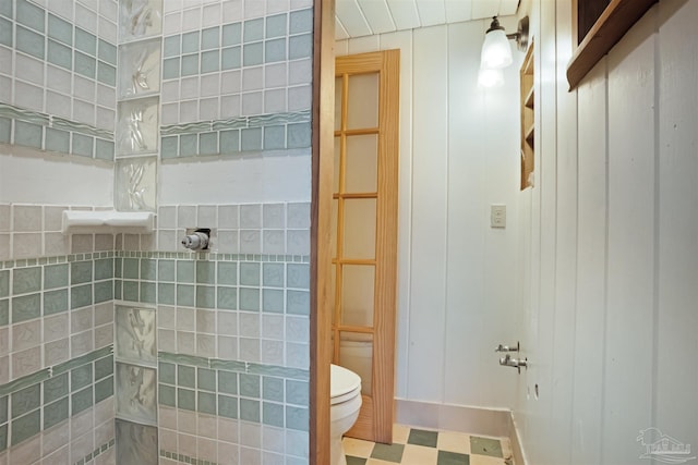 full bath featuring walk in shower, toilet, and tile patterned floors