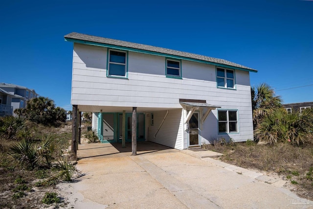 view of front of house featuring a carport and concrete driveway