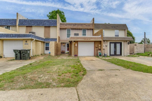 8140 Lillian Hwy, Pensacola, FL 32506 - multi unit property with french doors, concrete driveway, fence, a shingled roof, and a garage