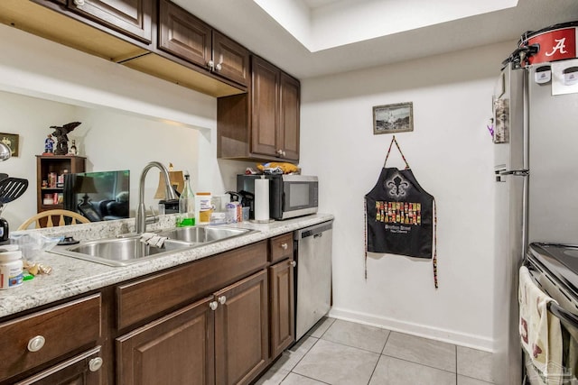 8140 Lillian Hwy, Pensacola, FL 32506 - kitchen featuring appliances with stainless steel finishes, a sink, light tile patterned floors, light countertops, and baseboards