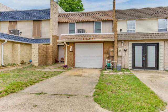 8140 Lillian Hwy, Pensacola, FL 32506 - multi unit property featuring french doors, concrete driveway, an attached garage, roof with shingles, and cooling unit