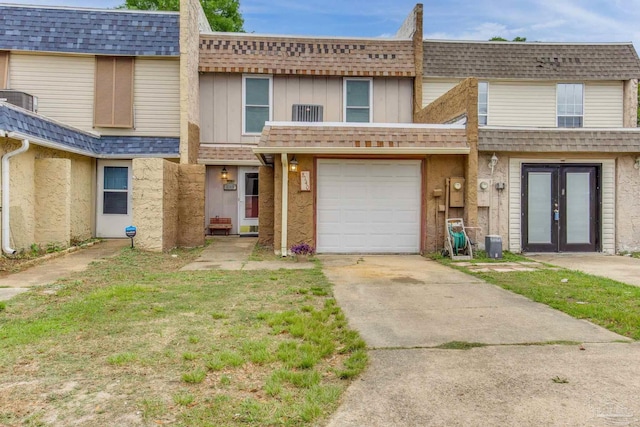 8140 Lillian Hwy, Pensacola, FL 32506 - view of property featuring french doors, driveway, central air condition unit, mansard roof, and roof with shingles