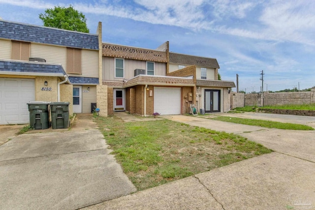 8140 Lillian Hwy, Pensacola, FL 32506 - view of property featuring fence, roof with shingles, a garage, and a chimney