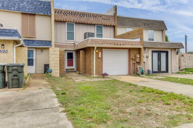 8140 Lillian Hwy, Pensacola, FL 32506 - view of property featuring french doors, central AC unit, driveway, and a shingled roof