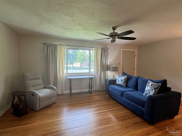 living room with hardwood / wood-style floors and ceiling fan