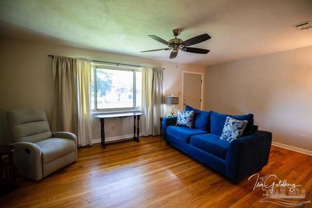 living room with ceiling fan and light wood-type flooring