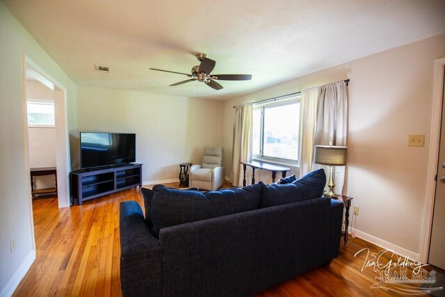 living room with ceiling fan and light hardwood / wood-style floors