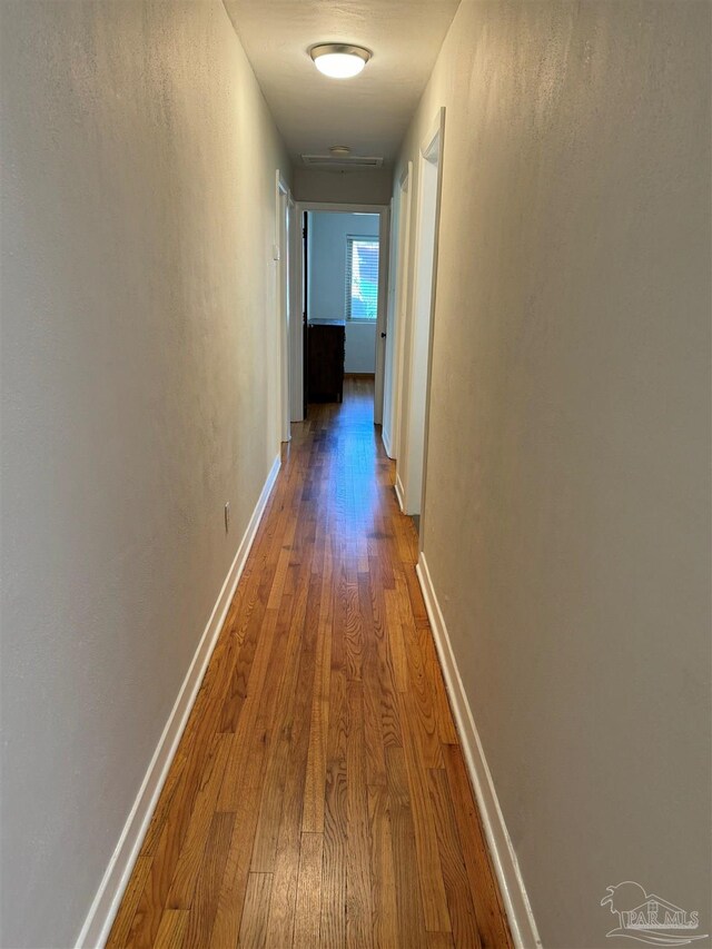 sitting room with ceiling fan and hardwood / wood-style floors