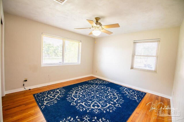 unfurnished bedroom with a closet, hardwood / wood-style flooring, and ceiling fan