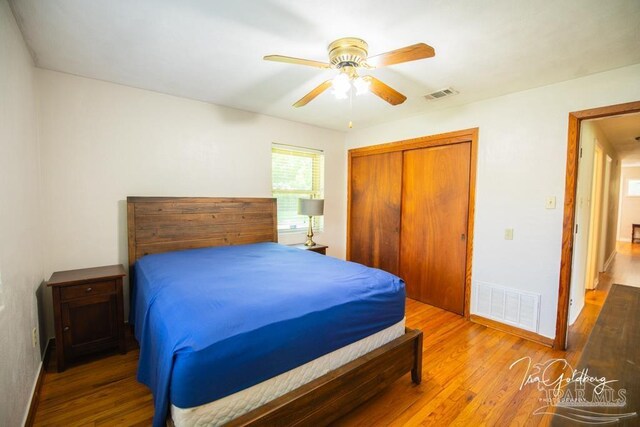 bedroom with ceiling fan, hardwood / wood-style flooring, and a closet