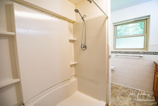 bathroom featuring vanity, tile patterned flooring, and tile walls