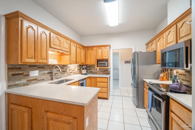 kitchen featuring sink, light tile patterned floors, backsplash, and appliances with stainless steel finishes