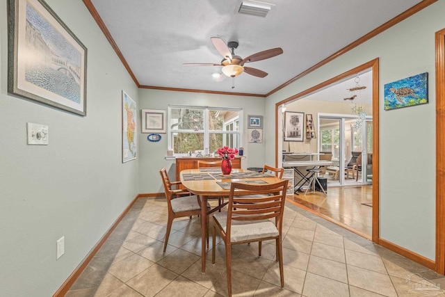 dining space featuring ceiling fan, ornamental molding, a textured ceiling, and light tile patterned floors