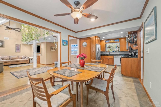 tiled dining space with ornamental molding and ceiling fan