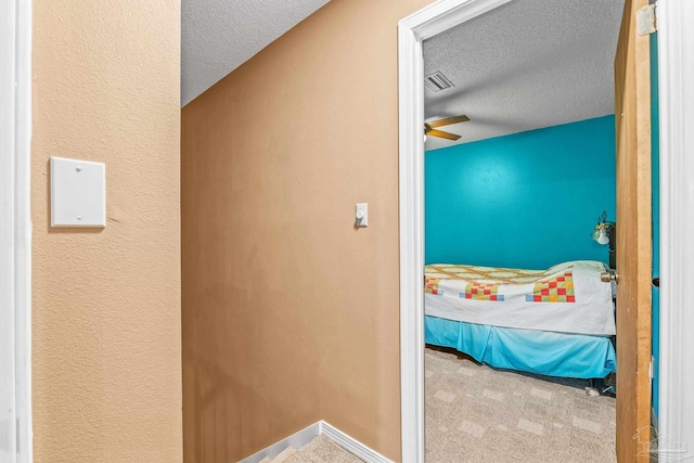 interior space with ceiling fan and a textured ceiling