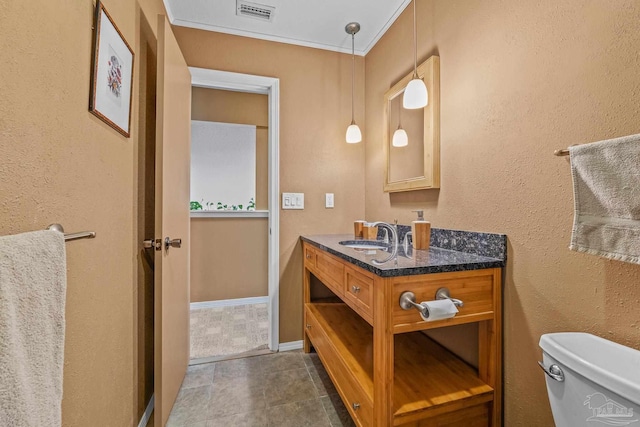 bathroom featuring vanity and toilet