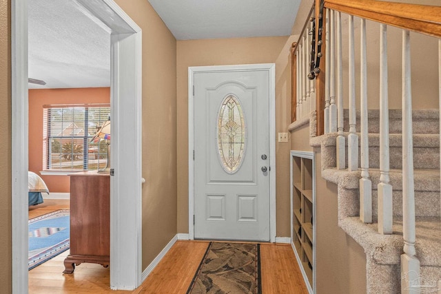 entrance foyer with a textured ceiling and light wood-type flooring