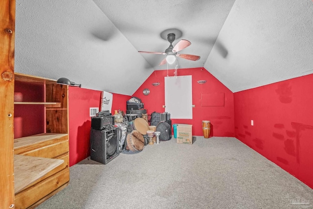 additional living space featuring lofted ceiling, ceiling fan, a textured ceiling, and carpet flooring